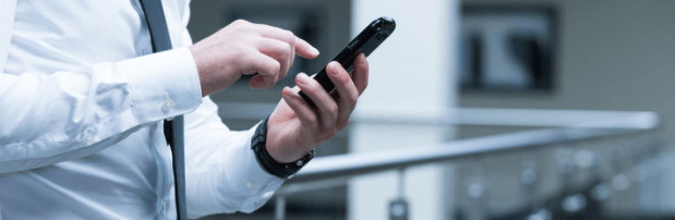 man in suit using mobile phone