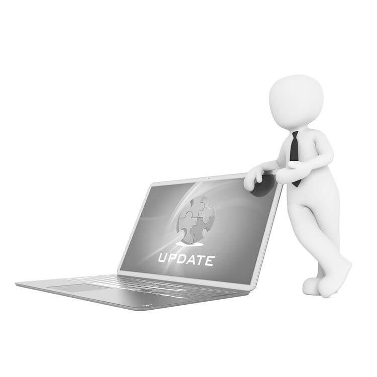 figure leaning on large laptop