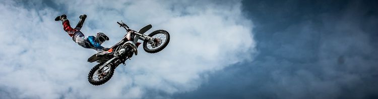 stunt bike with rider half dismounted