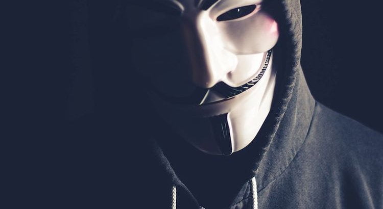 masked man with hooded sweatshirt