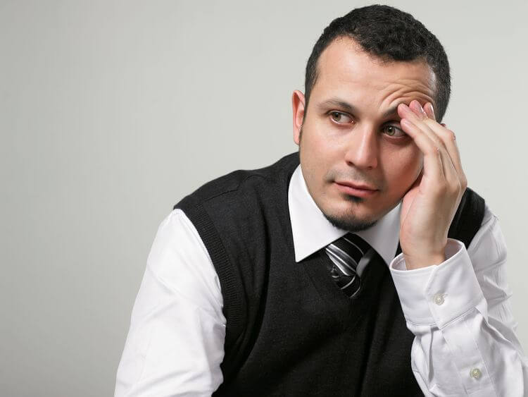 man thinking holding forehead