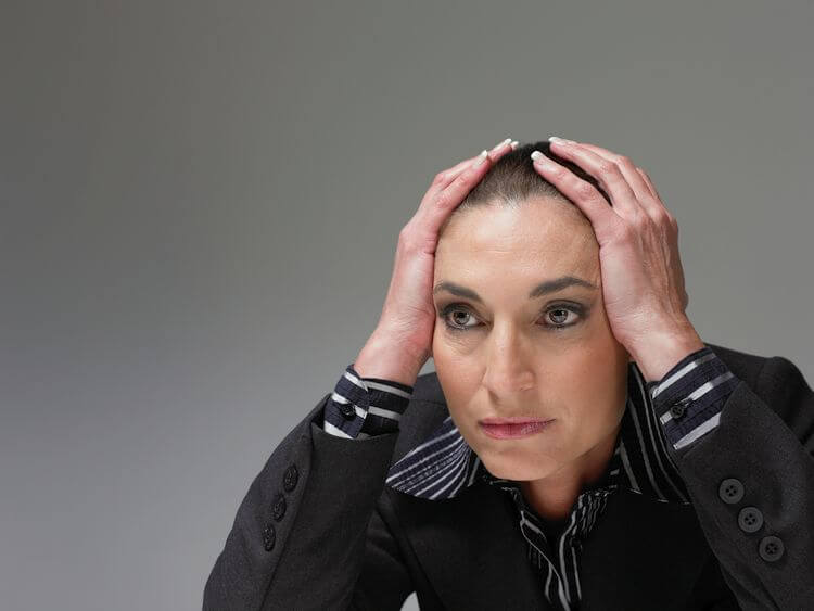 woman with hands on head