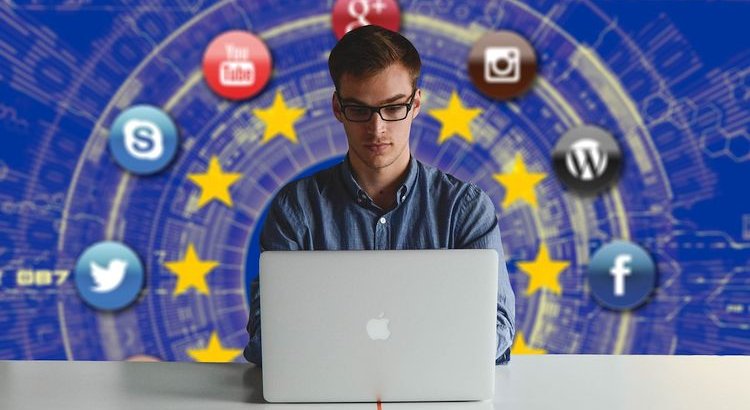 social icons behind man on computer