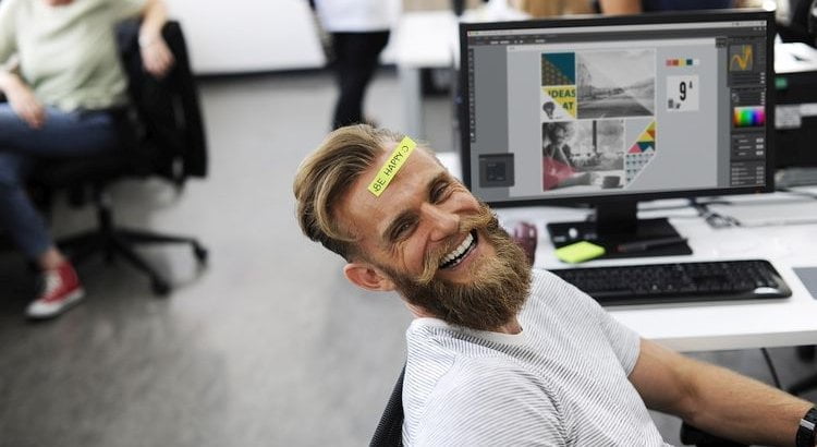 smiling employee by computer