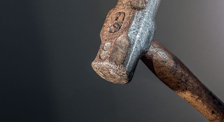 serif hammer crushing a nut1